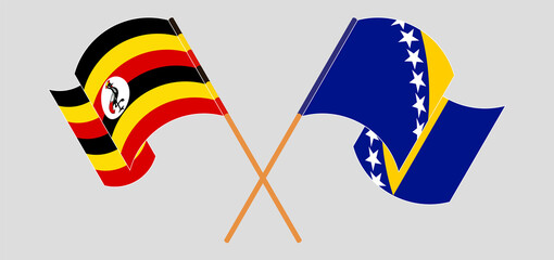 Crossed and waving flags of Uganda and Bosnia and Herzegovina