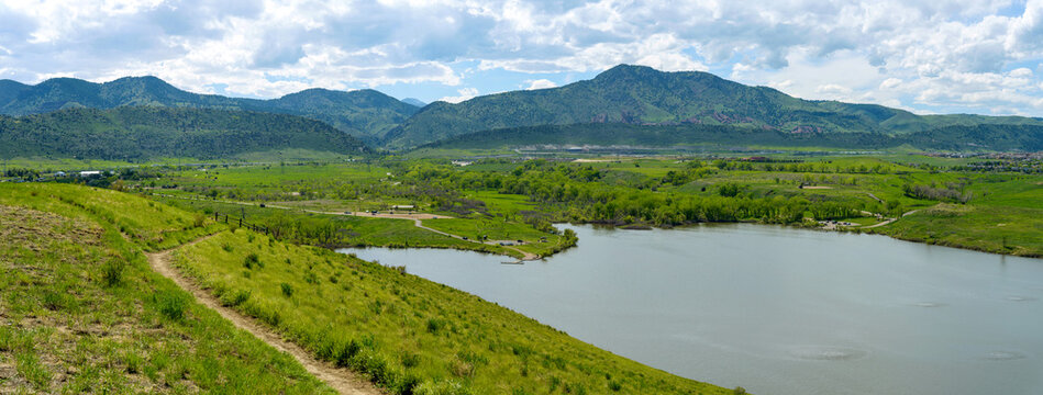 Bear Creek Lake - A panoramic Spring view of a biking trail winding at side of Mt. Carbon, overlooking Bear Creek Lake. Bear Creek Lake Park, Denver-Lakewood, Colorado, USA.
