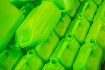 Many empty green plastic jerrycans background in warehouse, market, factory or exhibition
