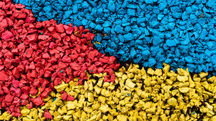 rubber crumb of different colors in the form of a flag