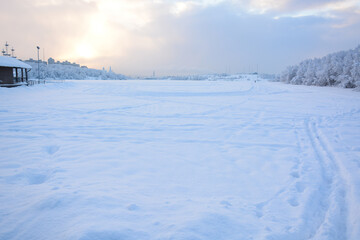Fototapeta premium MURMANSK, RUSSIA - FEBRUARY 10, 2021: Semonovskoye lake covered by snow in winter