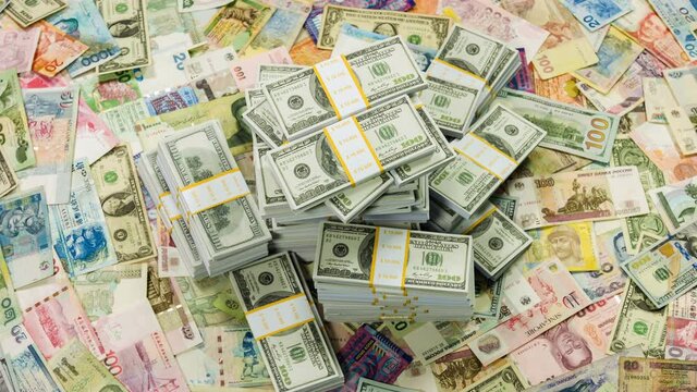 One million dollars and banknotes from different countries close up rotation.