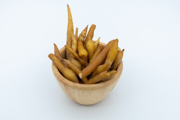 Fingerroot in wooden cup isolated on white background.