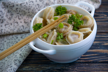 dumplings, sticks on wooden background