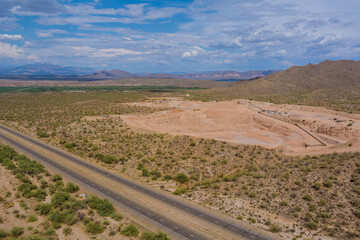 Heavy industry as a mining from above aerial view of excavator in open cast mine