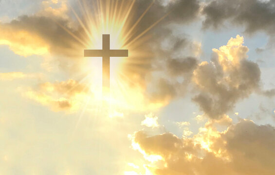 Christian cross appears bright in the gold sky