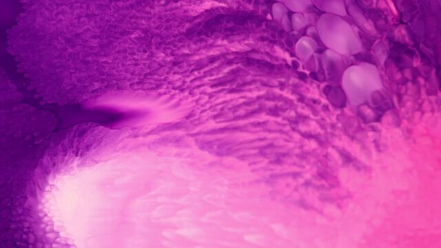 Flowing glitter waving surface. High Flow Fluid Painting. Beautiful metallic pink, purple, lilac texture paint close-up. Liquid slow motion Art. Colorful Chaos Turbulence. 
