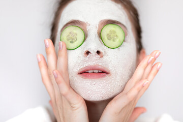 Beauty shot of housewife woman with mask cream on her face and h