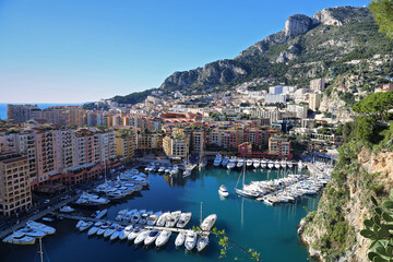 High view of the marina of Monaco Fontvieille with its moored luxury yachts, against a blue sky. Azure coast. France..