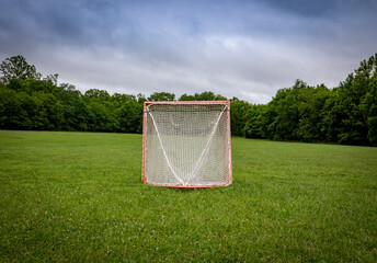 Panorama of a lawn field with lacrosse goals stored and locked together in Veteran's park in...