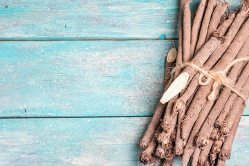 Bunch of raw Scorzonera or Spanish salsify on turquoise wooden table