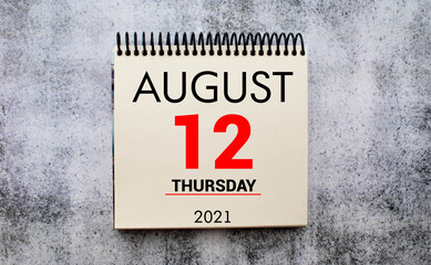 tear-off calendar sheet with date August 12, concept
