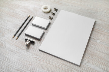 Blank stationery set on light wooden background. Corporate identity template. Responsive design...