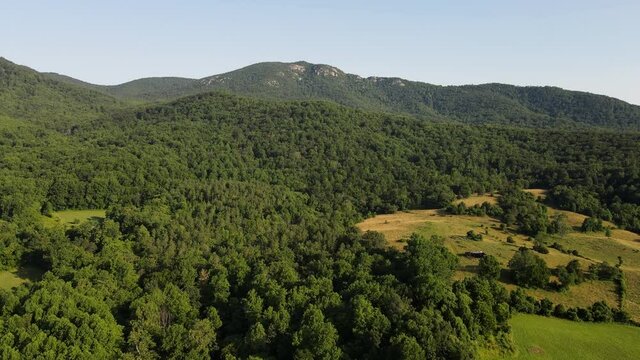 Scenic aerial overview of Shenandoah mountains and hills from above during summer sunset