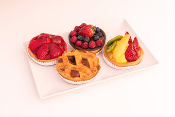 Tartlets with assorted fruits, strawberries, berries, kiwi and mango. Apple pie.