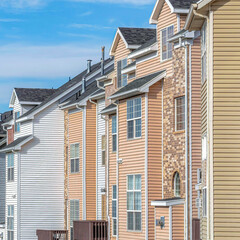 Square Townhouses on a sunny neighborhood with views of the valley and cloudy blue sky