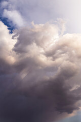 Fototapeta premium Heaven. Epic Dramatic storm grey white cumulus clouds in sunlight abstract background texture 