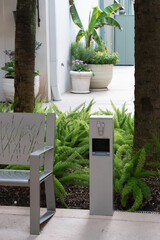 A phone charger and a bench in an outdoor retail area in The Woodlands, Texas.
