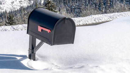 Pano Snowed in Black freestanding post mount mailbox against mountain in Park City