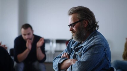Middle aged alcoholic sharing story with supportive group
