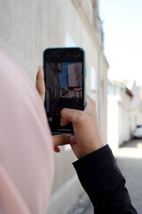 person taking a photo of building scenery using smartphone