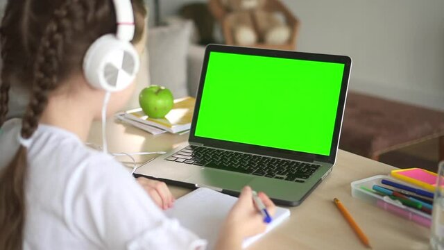Girl watch educational teaching video on green screen laptop, virtual class on distant lesson Spbd