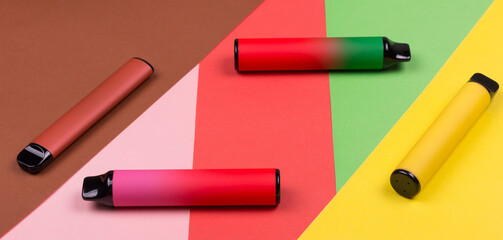 Disposable single pink e-cigarettes with saline nicotine. Pod systems of different colors. Devices...