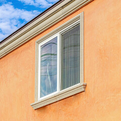 Obraz premium Square Windows and orange wall of building with flat roof in Huntington Beach CA