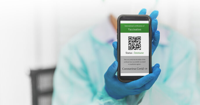 digital covid-19 vaccination certificate with QR code on smartphone
