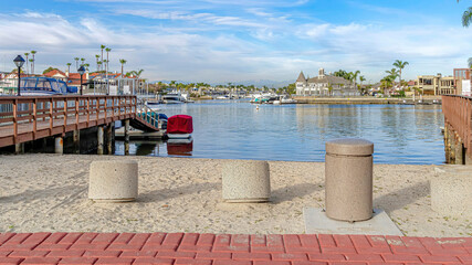Pano Scenic sea with boat docks under vibrant blue sky in Huntington Beach California