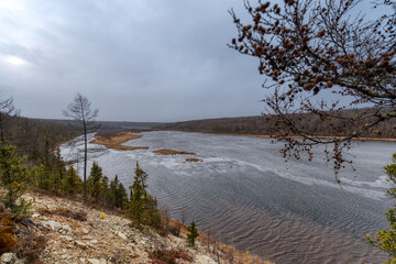 The banks of a wide taiga river. Irelyakh River, Yakutia Russia