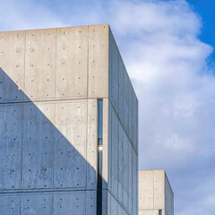 Square Concrete building exterior against blue sky and clouds at a school in San Diego