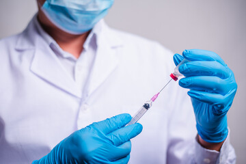 Doctor holding tube with Coronavirus vaccine and syringe. Healthcare And Medical concept.