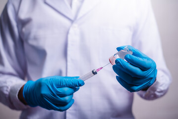 Doctor holding tube with Coronavirus vaccine and syringe. Healthcare And Medical concept.