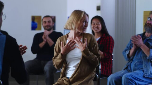 Happy woman telling about overcoming addiction