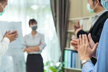 Asian businesswoman leader wear mask, report work to colleague team.