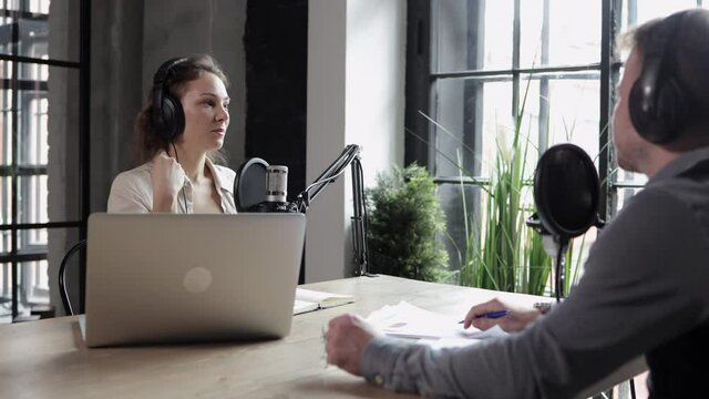 Man and woman recording radio podcast in studio, woman tell news, discuss social media Spbi. Two