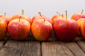 apple fruits in a row, old weathered wood table background