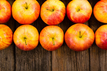 apple fruits in a row, old weathered wood table background