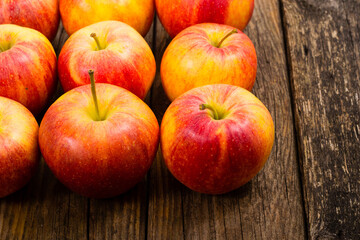 Naklejka na ściany i meble apple fruits in a row, old weathered wood table background