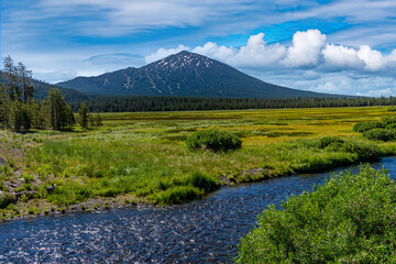 Todd creek and Mt Bachelor mountain with white puffy clouds in the late afternoon on a hot summer...