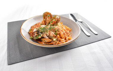 mixed seafood pasta with big tiger prawn, scallop shell clam and muscle in spicy chilli crab sauce or tomato paste sauce in white background western halal cuisine 