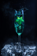 Cold blue cocktail with a star fruit garish on black background.