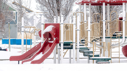 Pano Park on a scenic neighborhood with colorful playground on a snowy winter setting