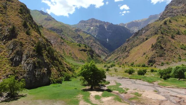 Stunning View Of Mountains With Urungach Lake At Summertime In Ugam-​Chatkal National Park, Uzbekistan. - Aerial Pullback Shot