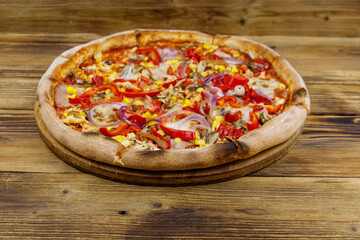 Delicious fresh pizza on a wooden table