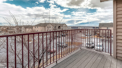 Pano Balcony of house with view of the neighborhood under blue sky with clouds