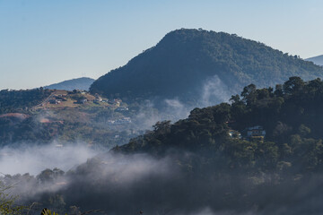 Dawn with a lot of fog in the mountains and hills in Itaipava, Petrópolis. Mountain region of Rio de Janeiro, Brazil. Aerial view. Selective focus.