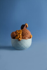 chocolate peanut butter ice cream, blue bowl and blue background 