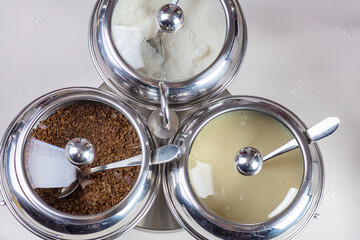 Fototapeta na wymiar Sugar, milk and coffee in bowls.